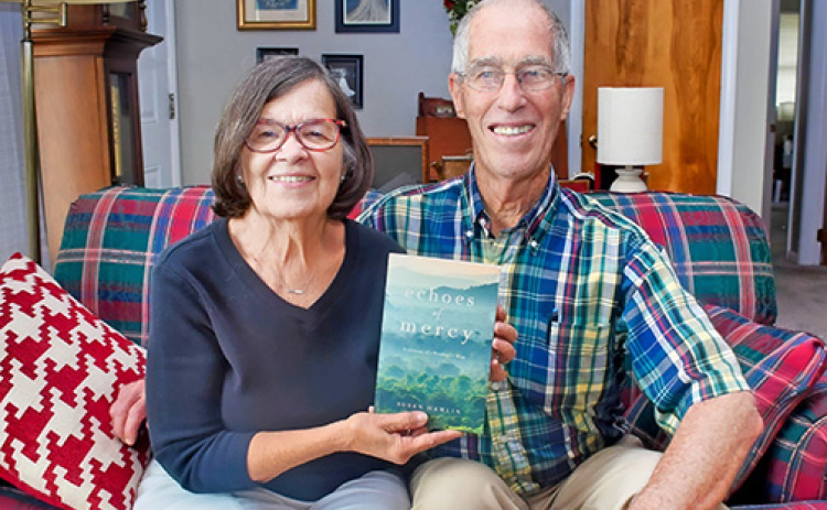 Susan Hamlin displays a copy of her first book, ‘Echoes of Mercy’ which she wrote about the couple’s many years of struggle in raising their adopted son, Nate. Her husband, Newton, a retired Bible translator, served as editor on the project.