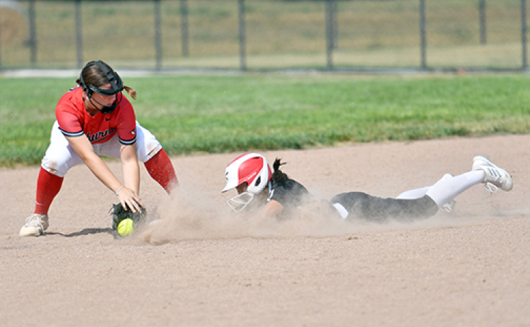 Aurora’s Emely Gonzalez gets dirty with a safe slide into second base during the Huskies’ 8-2 loss to Auburn in Friday’s tournament. Gonzalez collected four hits and two RBIs through Aurora’s first four games.