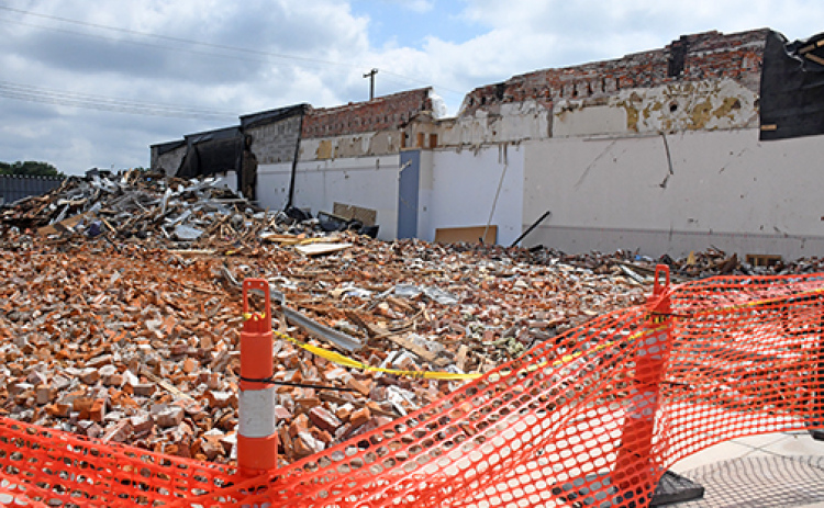 Bricks and debris left in the rubble on the former Gambles building site in downtown Aurora will be removed in a process expected to begin Wednesday.