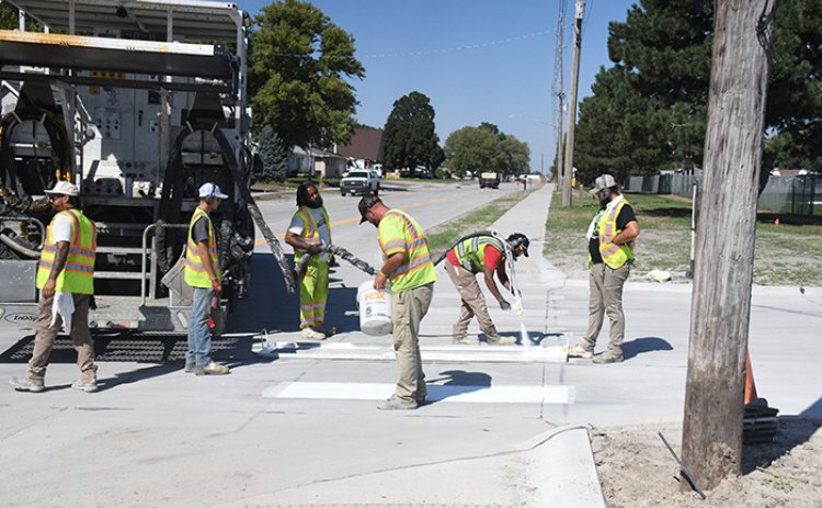 Crews were busy painting lines on the new portion of 1st Street near the school Thursday afternoon.