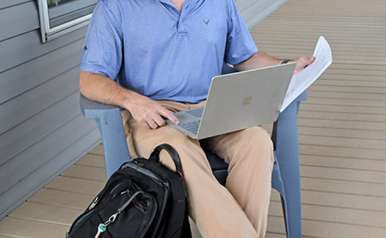 Patent attorney Jeff Morris doesn’t usually work while sitting the deck of his home in Aurora, but he could. Because he works remotely with clients from around the nation, all he needs to do his job is his laptop, an internet connection and the materials in the backpack sitting at his feet.