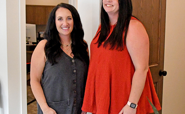 Michaela Robertshaw Garrett, left, and agent Celie Holliday stand in the newly remodeled offices of the M Robertshaw Insurance Agency, located on the east side of the downtown square.