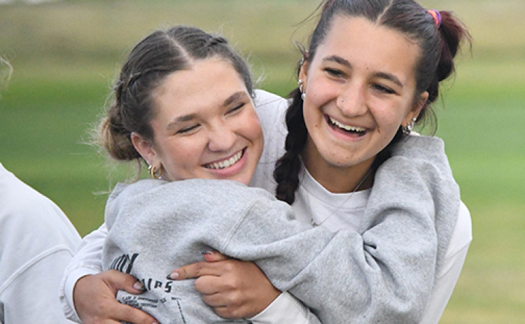 Aurora seniors Ella Eggleston (left) and Lexi Ericksen celebrate after not only a team win in Central City, but an individual gold medal for Eggleston.