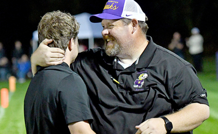 Hampton coach Jereme Jones (right) celebrates with his assistant coach and son, Noah, after the Hawks picked up a ranked win over Pawnee City at home Friday, 27-24.
