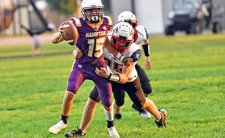 Landen Rojewski wiggles out of a tackle during Hampton’s 43-14 win over Parkview Christian Friday. Rojewski scored in all three ways Friday -- passing, rushing and receiving.