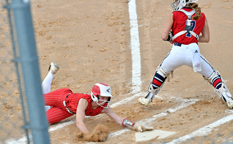 Vivi Fahrnbruch leans out to avoid a potential tag at the plate to score one of Aurora’s two runs in a 12-2 loss to Norris in last week’s B-7 district matchup.