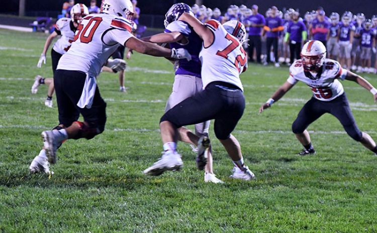 Aurora’s defense almost recorded a safety on this first-quarter play Friday at Milford, as defenders Angelo Holke (50), Tucker Theriot (72) and Gavin Logue (26) bring down a runner right at the goal line.