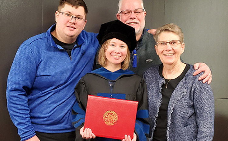 Katie Muilenburg (center) is a postdoctoral fellow at the National Cancer Institute Center for Cancer Research in Bethesda, focusing on liver cancer research. Pictured with Muilenburg from left are her brother Nathan, father Jeff and mother Cyndi.