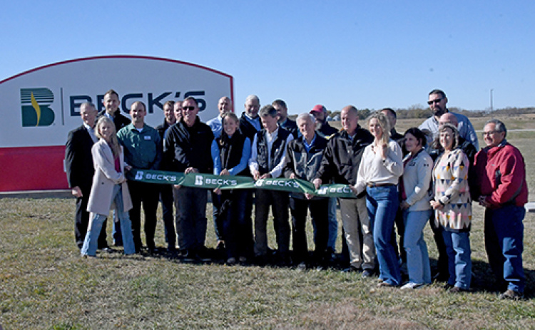 Beck’s Hybrids President Scott Beck (center) prepares to cut the ribbon on the company’s newest seed corn facility, the former Syngenta plant near Phillips, on Friday. With him are his father, Sonny, the company’s CEO, as well as other Beck’s officials and representatives of various community organizations.