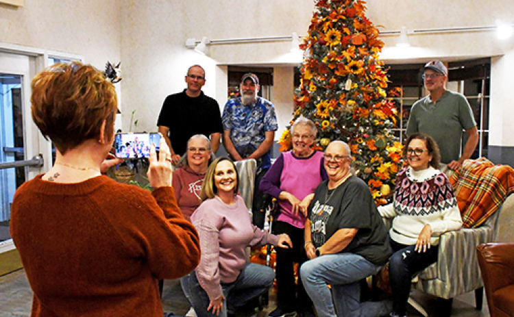 Administrative assistant Jenny Scheil takes a picture of resident Loretta Bykerk (center) with her family. The Christmas tree was declared one of the winners of East Park Villa’s employee decoration contest. It was decorated by Jenny Scheil and the maintenance department.