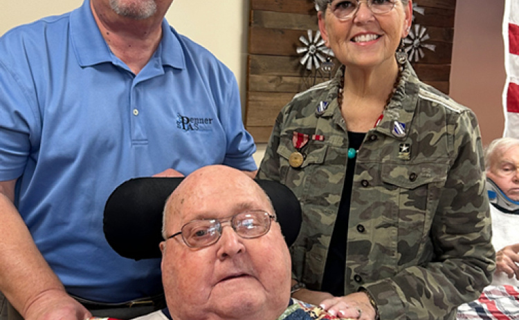 U.S. Army veteran Ken Werner was presented with a Quilt of Valor during a ceremony hosted by the Nimble Thimble Quilt Guild on Veterans Day. Pictured with Werner are his children Scott and Mickie.