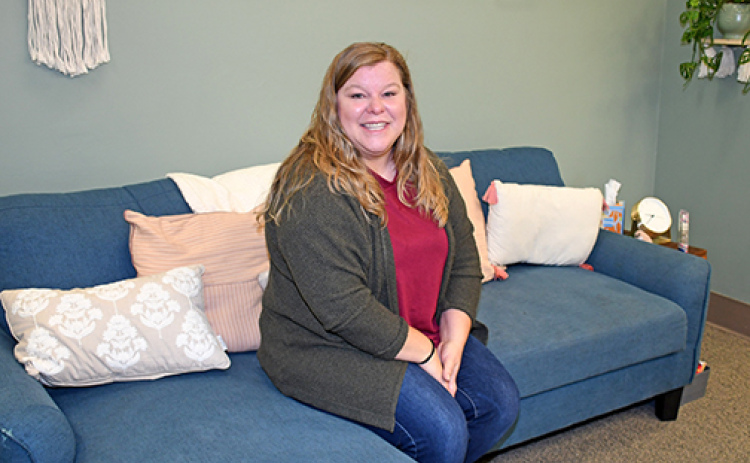 Annie De La Cruz sits in her new office space at Seeds of Change Counseling and Consulting, located at 207 S. 16th Street in Aurora.