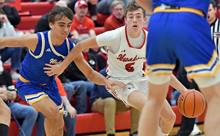 Aurora’s Ryan Staehr dribbles through heavy Wahoo traffic during the Huskies’ 66-43 loss to the Warriors Saturday.