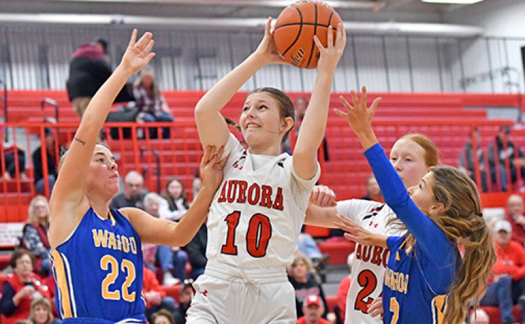 Kenna Merrihew pulls down an offensive rebound in heavy traffic during Aurora’s 43-35 loss to Wahoo Saturday.