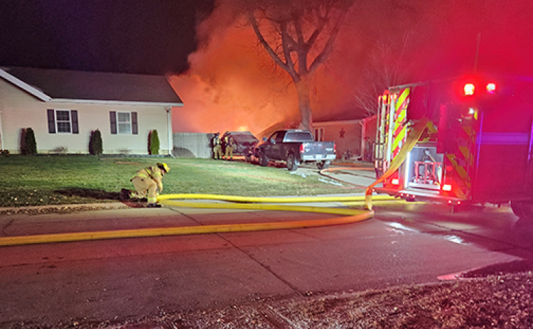 Aurora firefighters battle a garage fire early Monday morning at 409 14th Street in Aurora.
