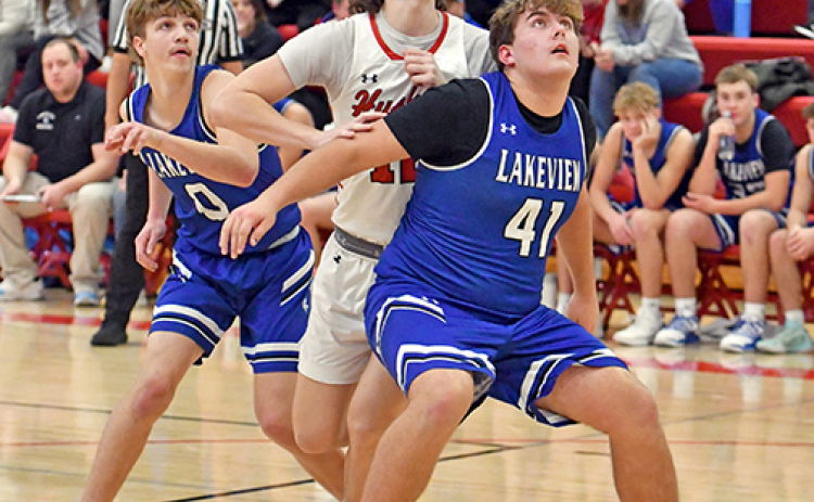 Dain Vap fights through a double team on a free throw shot during Aurora’s win over Lakeview Friday.