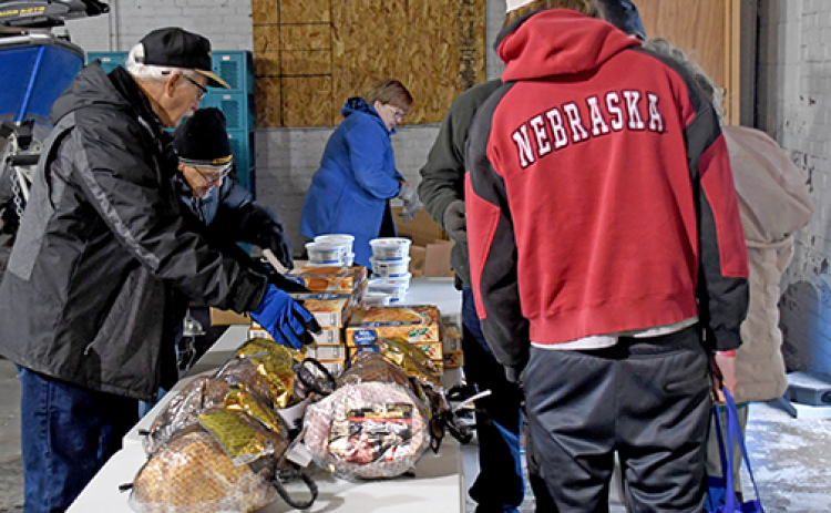 A team of Hamilton County Food Pantry volunteers spent an hour Saturday morning giving out food baskets so that 175 people could have a Christmas dinner.