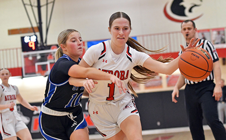 Aurora’s Hailey Hoff dribbles around and through contact during the Huskies’ 55-23 home win over St. Paul Thursday.