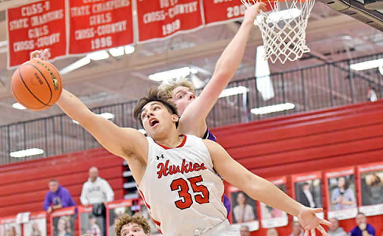 Aurora’s Tucker Theriot battles for an offensive board in the Huskies’ win over Milford Thursday.