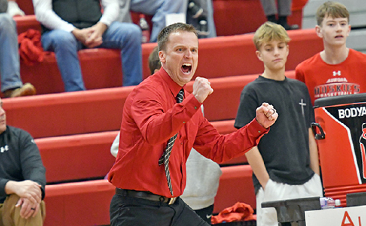 Aurora coach Scott Phillips is all fired up for his team forcing a defensive turnover in the back court during the Huskies’ 43-34 loss to Class C1 No. 1 Milford Thursday.