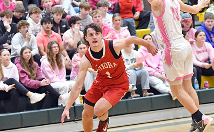 Aurora’s Canon Allen drives around the Kearney Catholic defense in a 68-30 win over the Stars. Allen was a perfect 5-for-5 in the game shooting with 14 points for the Huskies.