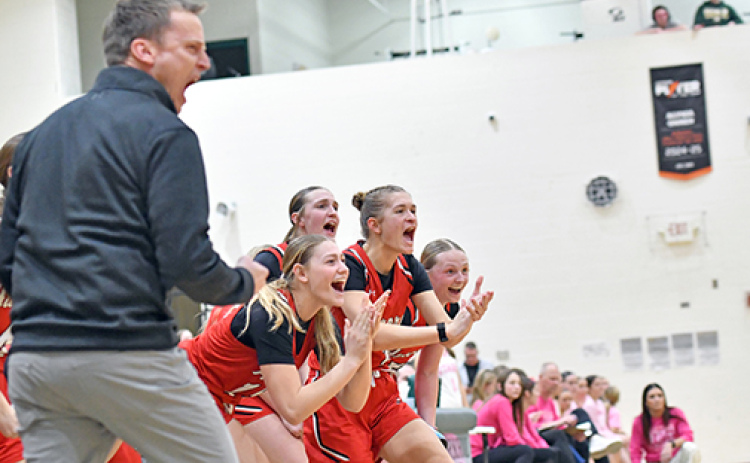 Aurora’s bench celebrates a made bucket during the Lady Huskies’ 52-35 win at Kearney Catholic Thursday. Aurora enters this week’s Central Conference tournament as the No. 1 seed.
