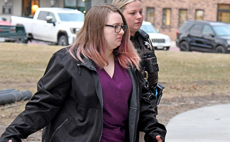 Tiffany Cure is escorted to trial Thursday morning by Deputy Sheriff Victoria Peters. Jurors heard a fourth day of testimony from witnesses for the prosecution on Monday.