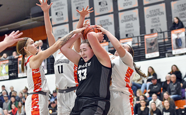 H&H sophomore Sophie Minary is completely surrounded by three Giltner/Harvard defenders, including Tabi Forney (far left), Peyton Schutt (11) and Kailyn Wilson (behind). G/H girls rallied for a 69-63 double overtime win over the Bearcats Friday.