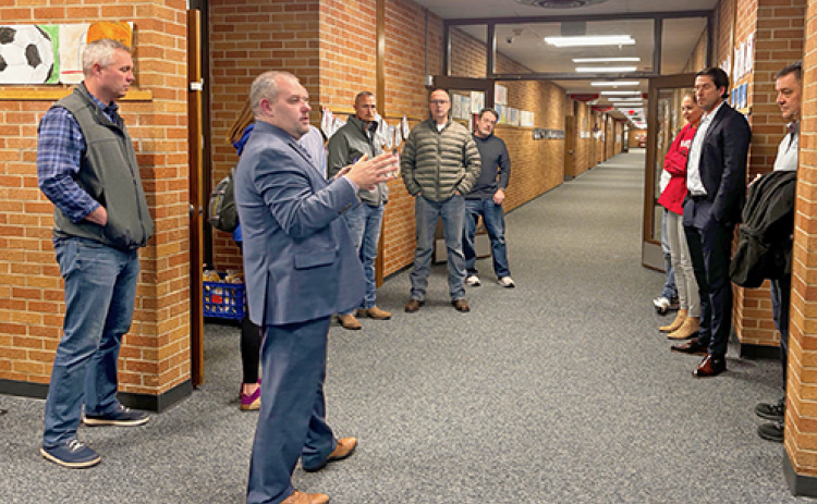 An advisory committee that has been studying the district’s facility needs tours a school facility during a recent meeting.