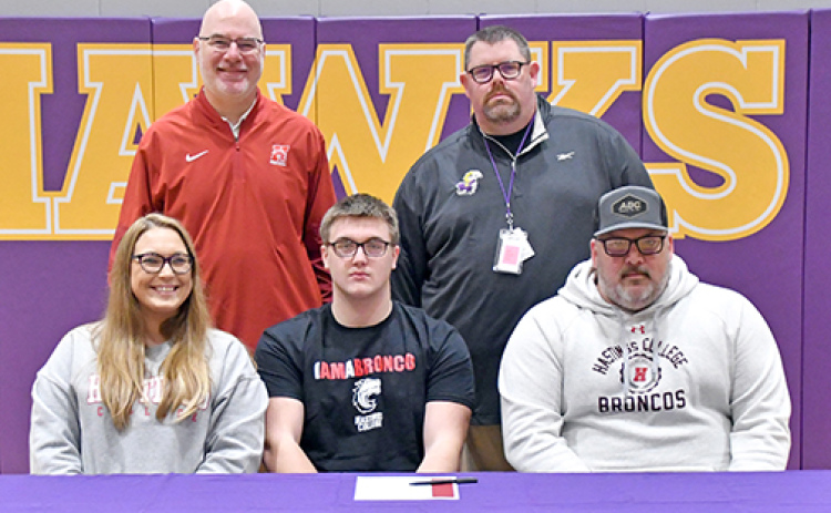 Hampton’s Kyler Luebbe signed with Hastings College to play football March 3, alongside his parents, Heather Reisbeck and Seth Luebbe, as well as Hastings coach Matt Franzen and Hampton coach Jereme Jones.