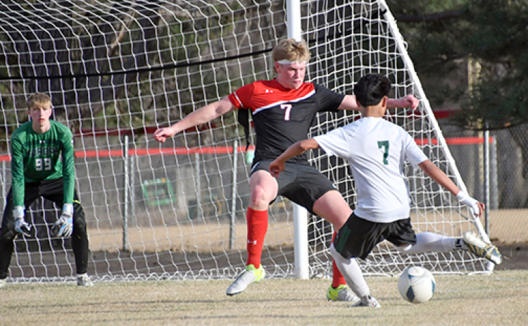 Garrett Kuehner looks to stop the ball on the Schuyler attack during Thursday’s 5-0 loss to the defending champion Warriors.