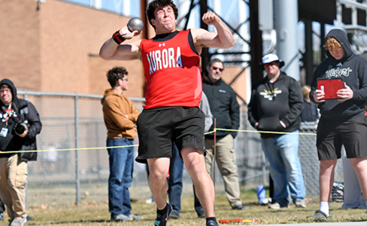 Aurora junior Derek Russell, shown here throwing the shot put at Friday’s Aurora Invite, set a new school record in the discus with a throw of 187-9. Russell won both throwing events on the day.