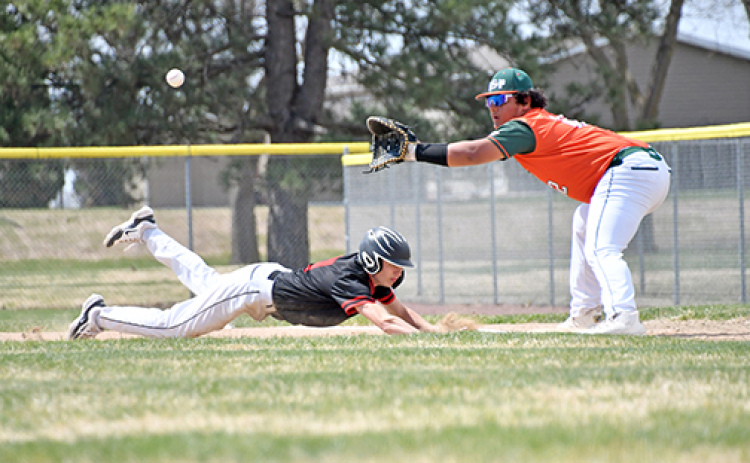 News-Register/Richard Rhoden Aurora’s Jack Carstensen dives back to first base to avoid the pickoff during the Huskies’ 12-0 win in game one over Maxwell St. Pats Thursday. The Huskies picked up two wins that day over Maxwell, including a wild 16-12 victory in game two.