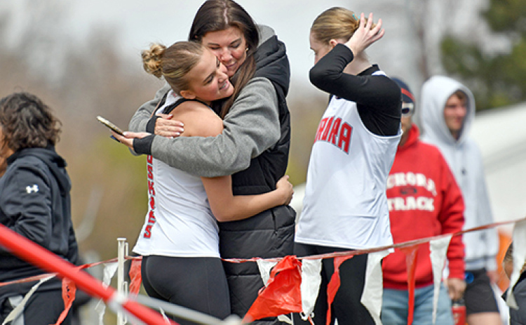 Aurora freshman Stella Peterson gets a big hug from her Mom, Sunny Wendt, after setting a new personal record in the triple jump with a mark of 37-7 to win the event at Broken Bow Friday.