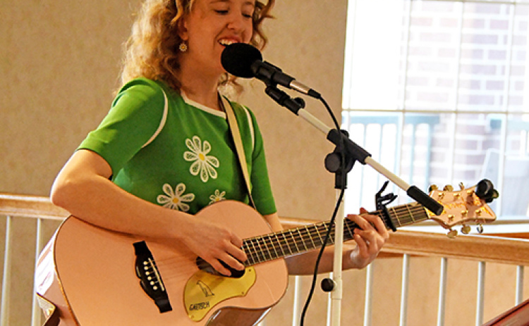 East Park Villa housekeeper Maddy (Barnes) Baker performs for residents at East Park Villa during the grand opening of The Grille on Friday, March 27. Baker has showcased her musical talents around the area, often performing songs from the 50s and 60s.