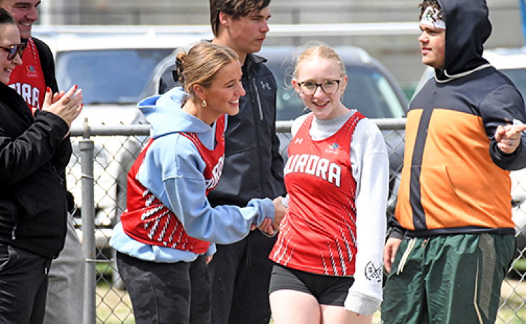 Sofia Van Veldhuizen (left) congratulates her sister Adelyn, after she competed in the Unified Track shot put competition at the Central City Invite on Friday. The sisters along with Lakota Von Ohlen and Ava Paulson placed second in the girls 4x100 relay race.