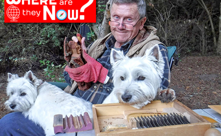 Marquette High School grad Scott Beyer worked for the U.S. Forest Service for 36 years as a silviculturalist and timber planner in Oregon. Now retired, he spends his time carving wood. Pictured with him are his terriers, Baxter and Toby.