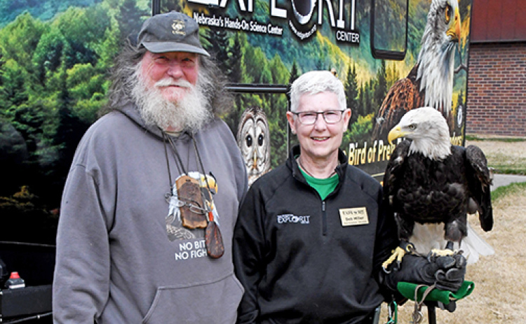Virginia wildlife rescuer Tommy White and Edgerton raptor specialist Deb Miller pose with bald eagle Aquilla in front of the Explorit Center’s new raptor trailer. White had just delivered a barred owl and red-shouldered hawk rescued by his organization to add to the Edgerton’s raptor education program.