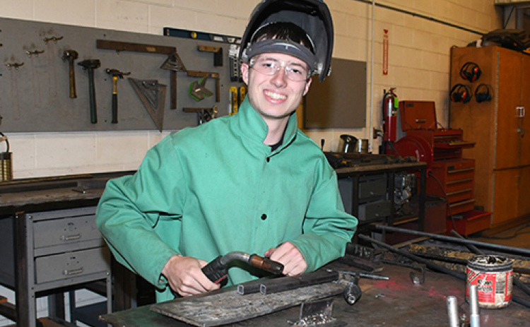 Brett Mellies paused for this photo in the ag shop during his final day of classes at AHS. Mellies plans to study mechanical engineering next fall at UNL.