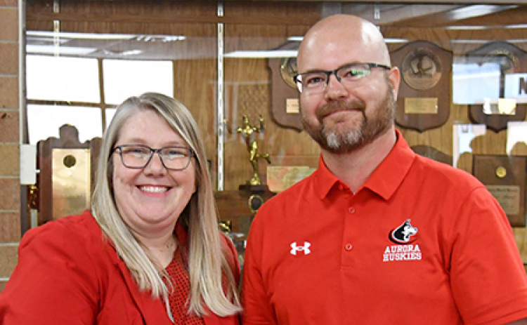 Nebraska School Counselor Association Executive Director Malinda Jean Baptiste congratulates Aurora High School Counselor Jacob Willems after naming him as the Nebraska School Counselor of the Year for 2026.