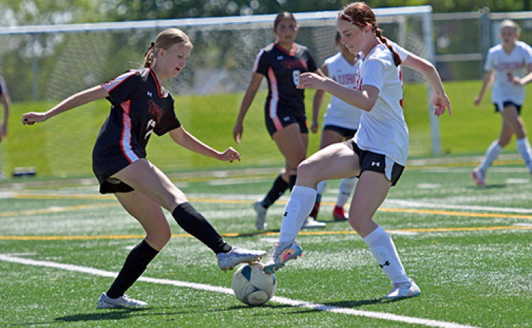 Aurora’s Paityn Wyatt battles for possession near the midfield during the second half of the Lady Huskies’ 1-0 loss to Hastings in Saturday’s B-3 district opener