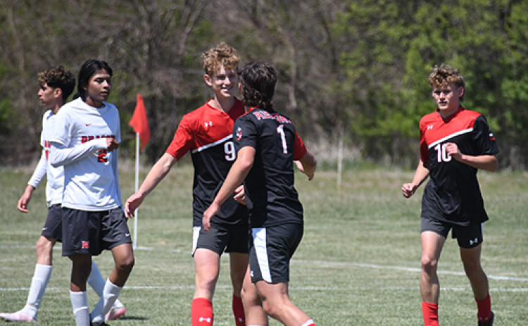 Alex Dick (9) gets congratulated by teammate Canon Allen after one of Dick’s five goals during Saturday’s win over Madison. Dick’s five goals in a single game ties Allen’s single-game school record, which was set earlier this season.