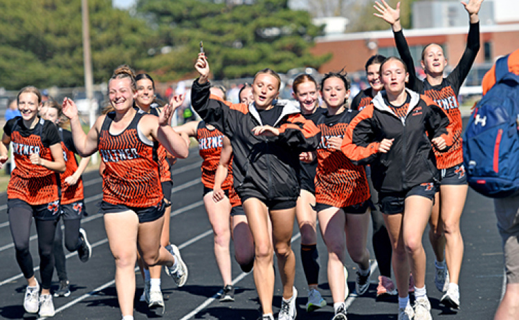 Members of the Giltner girls track team take a celebratory lap around the track after clinching the Twin Valley Conference title Saturday in Shelton. It was the Giltner girls’ first conference title since winning the CRC championship in 2019, part of a five-year run.