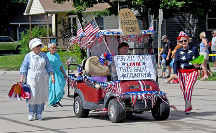 This entry in Sunday’s Booster Days Parade in Hampton won the prize for Best Theme with its America 250-themed costumes and decorations. From left above are Sharon Klute as U.S. Flag Creator Betsy Ross, Damaris Olsen as the Statue of Liberty, Jean Anne Schmidt as Miss USA and Loa Winter as Uncle Sam.