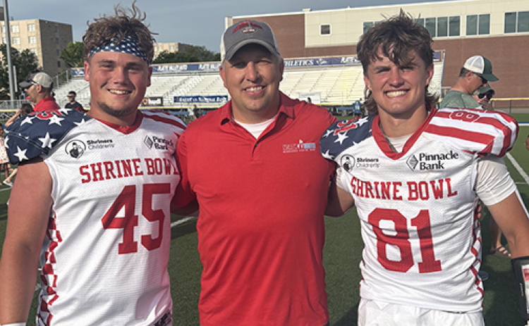 Wade Miller, a 2002 Aurora graduate now serving as an assistant coach in Seward, was an assistant coach for the South team in Saturday’s Shrine Bowl. He celebrated after the game with former Huskies Collin Stolpe and Canon Allen.
