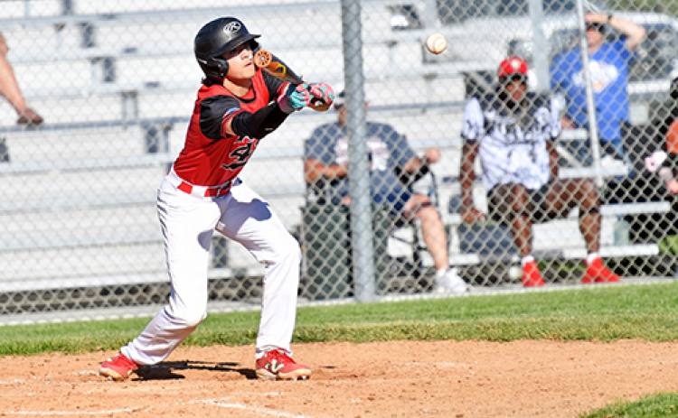 Keagan White lays down a bunt during Aurora’s win over Gering. White had three RBIs in the win.