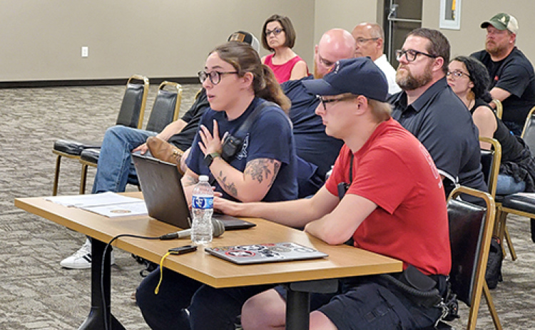 Amelia Guenther, left, and Chris Hyde address the Aurora City Council during last week’s meeting, where the local firefighters union made its case as to why Aurora’s ambulance service should remain public, not go private.