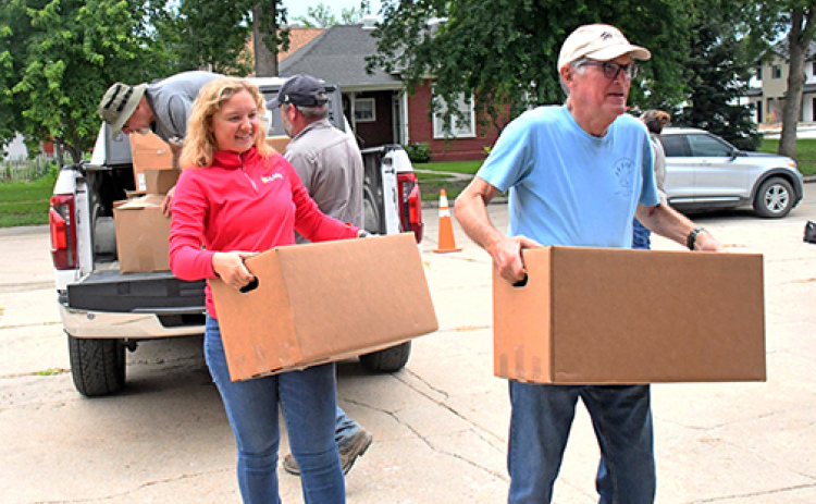 Volunteers carry food donations into the food pantry during last week's Can Care-A-Van