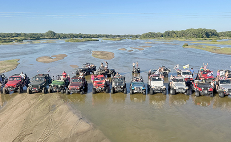 The water level in this picture of a group of River Rats enjoying a day on the river is almost too low for maximum jeeping enjoyment, according to River Rats President Jake Brown. He says members like a water flow of about 1,200 cubic feet per second so that riders can be in the water to cool off on a hot day.