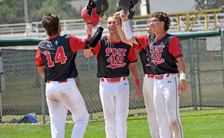 Sawyer Kiner is met at the plate by Jace Dorsey, Jack Carstensen and Lukas Fry after his grand slam during Aurora’s 13-5 win over Overton in Saturday’s elimination game at the Area 6 tournament in Holdrege.